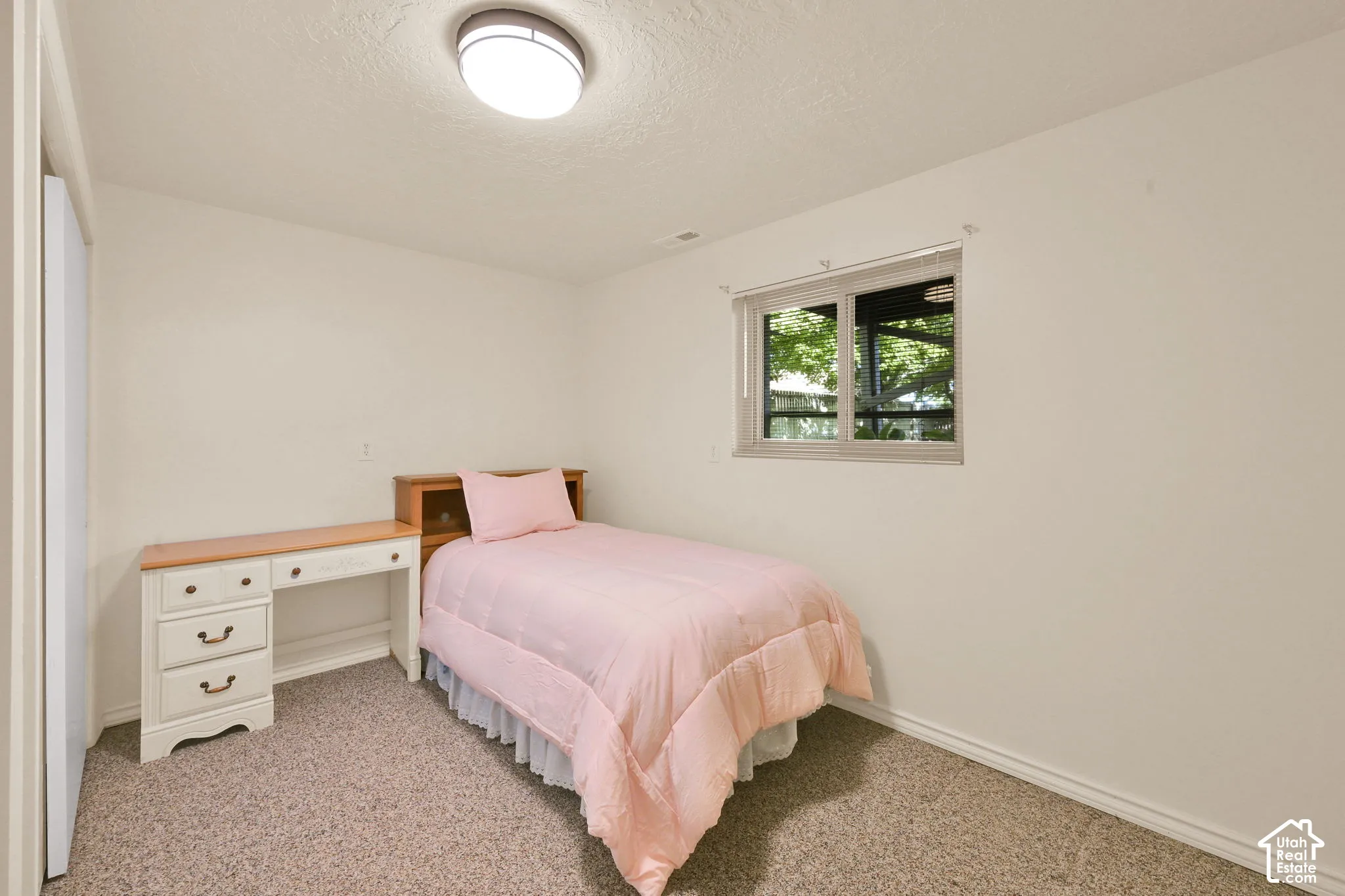 Bedroom 6. Wall-to-wall carpeting and a single window with  blinds