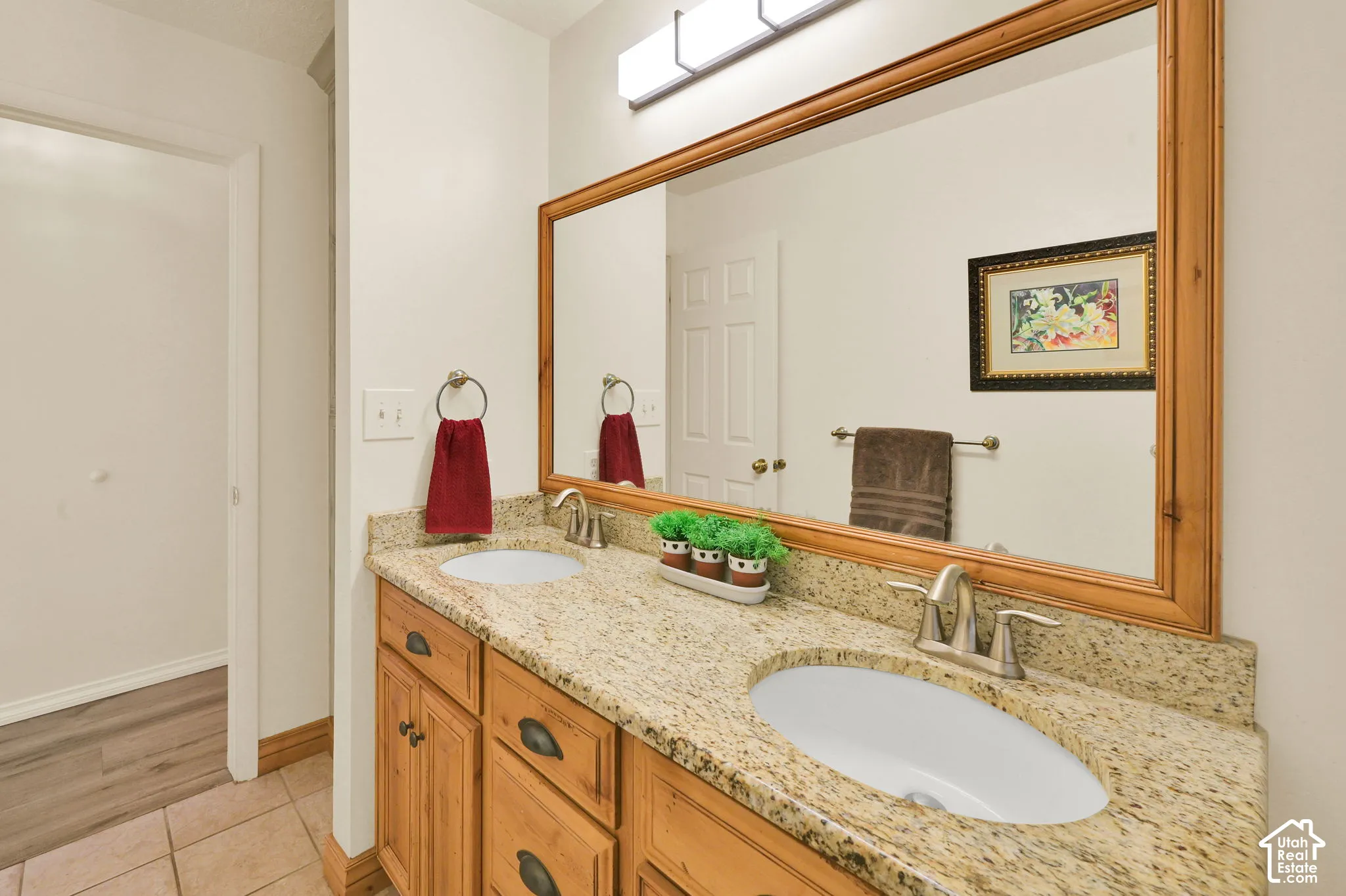 Upstair full bathroom. Dual vanity with granite countertops, undermount sinks, and a framed mirror