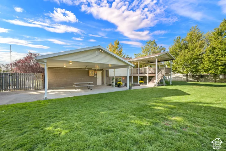 Expansive lawn with a two-story back deck and covered patio