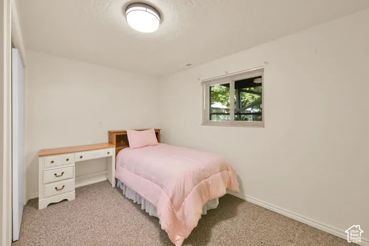 Bedroom 6. Wall-to-wall carpeting and a single window with  blinds