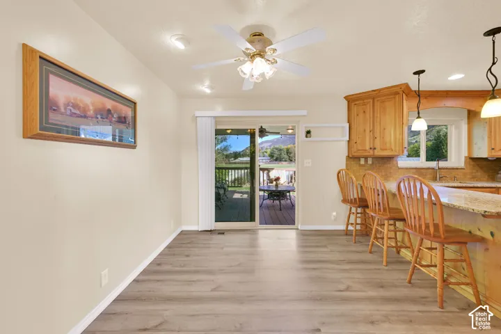 Wood-finish flooring, recessed lighting, and a ceiling fan