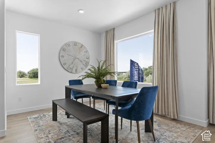 Recessed ceiling lighting, light wood-finish flooring, and large windows