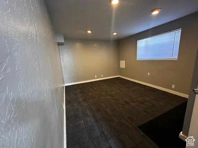 Interior space featuring textured walls, recessed ceiling lighting, and wall-to-wall carpeting