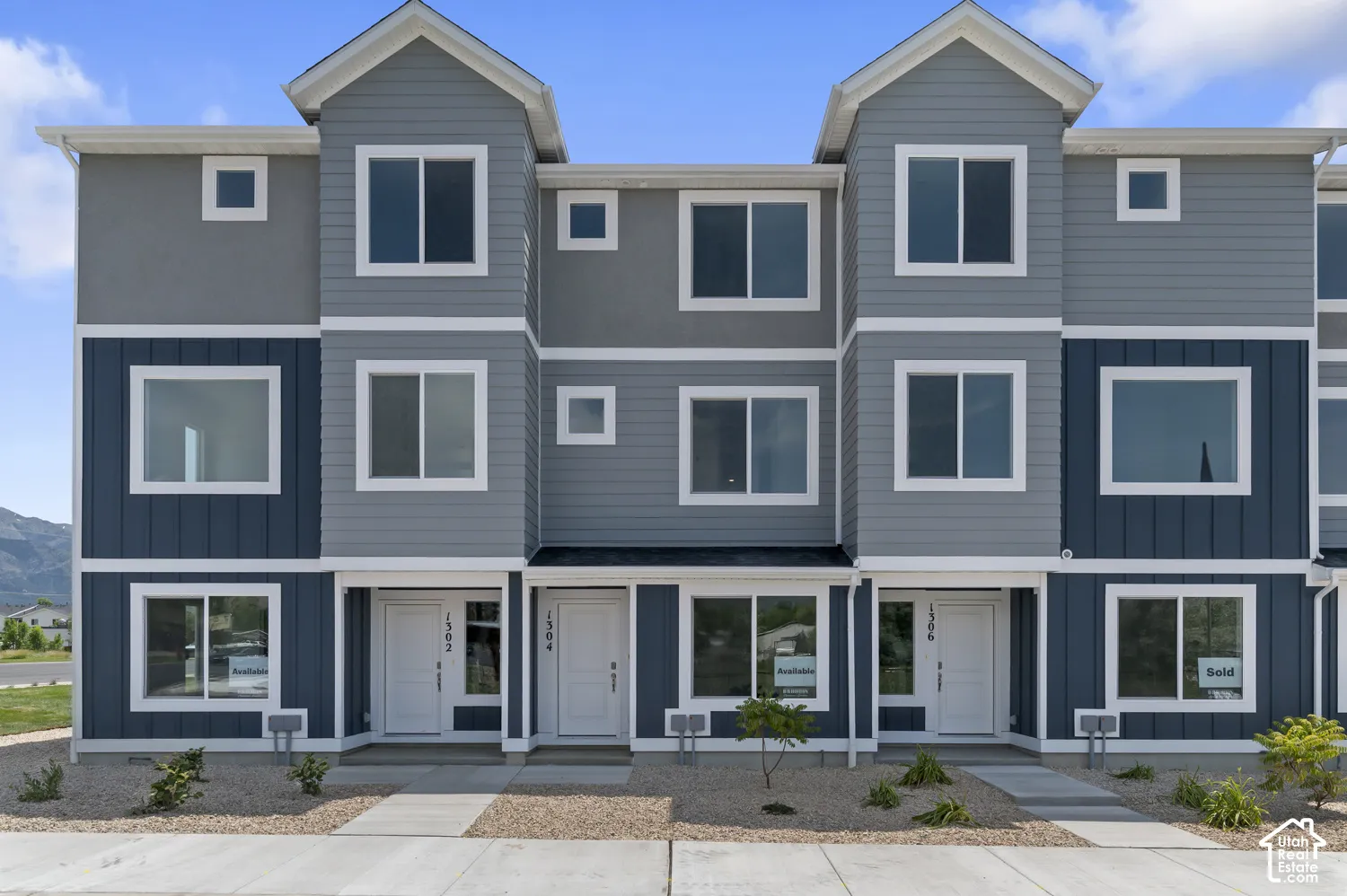 Multi-story exterior with a gabled roofline and contrasting siding