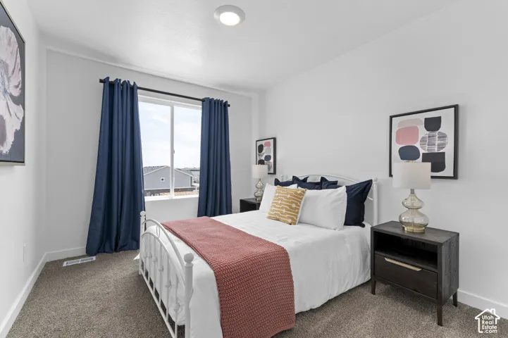 Recessed ceiling lighting, a large window, carpet flooring, and white painted walls