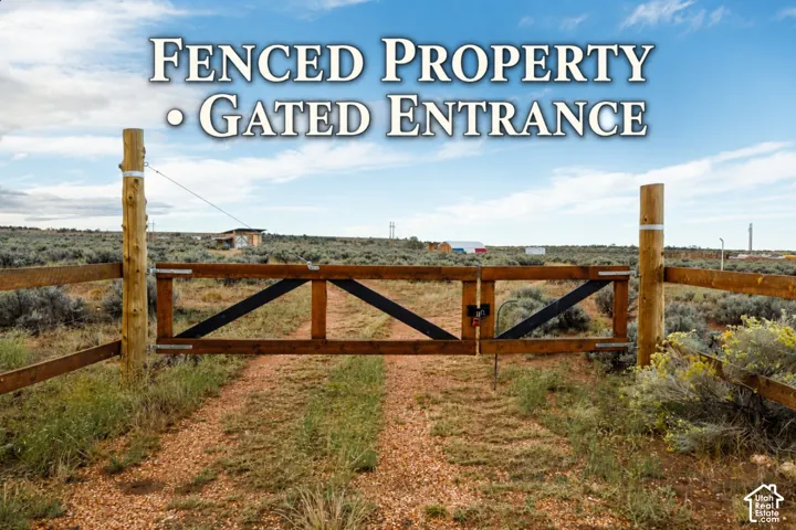 Wood-post fencing with a double-swing gate entrance