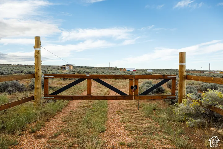 Wooden gate entrance with rustic fencing