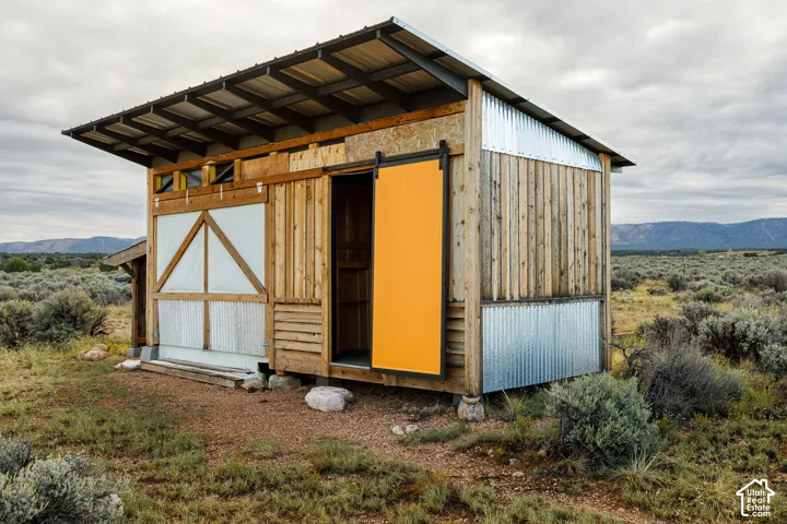 Wood-clad structure with corrugated metal accents and a metal roof
