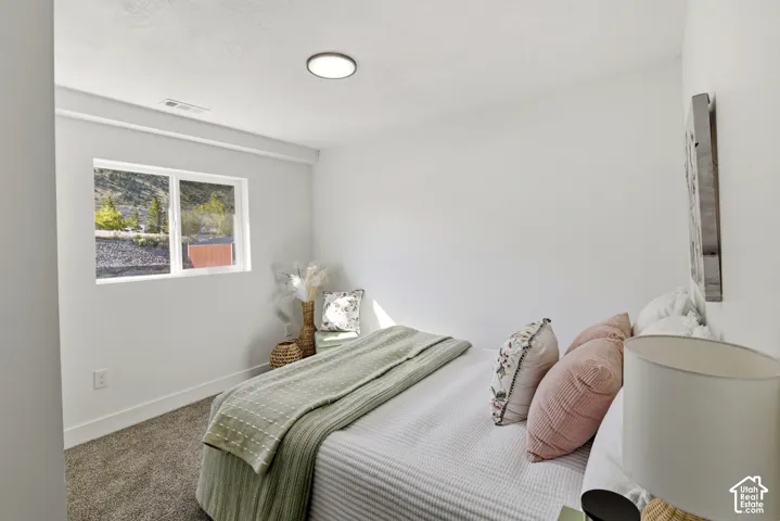 White walls with recessed ceiling lighting, carpeted flooring, and a single window