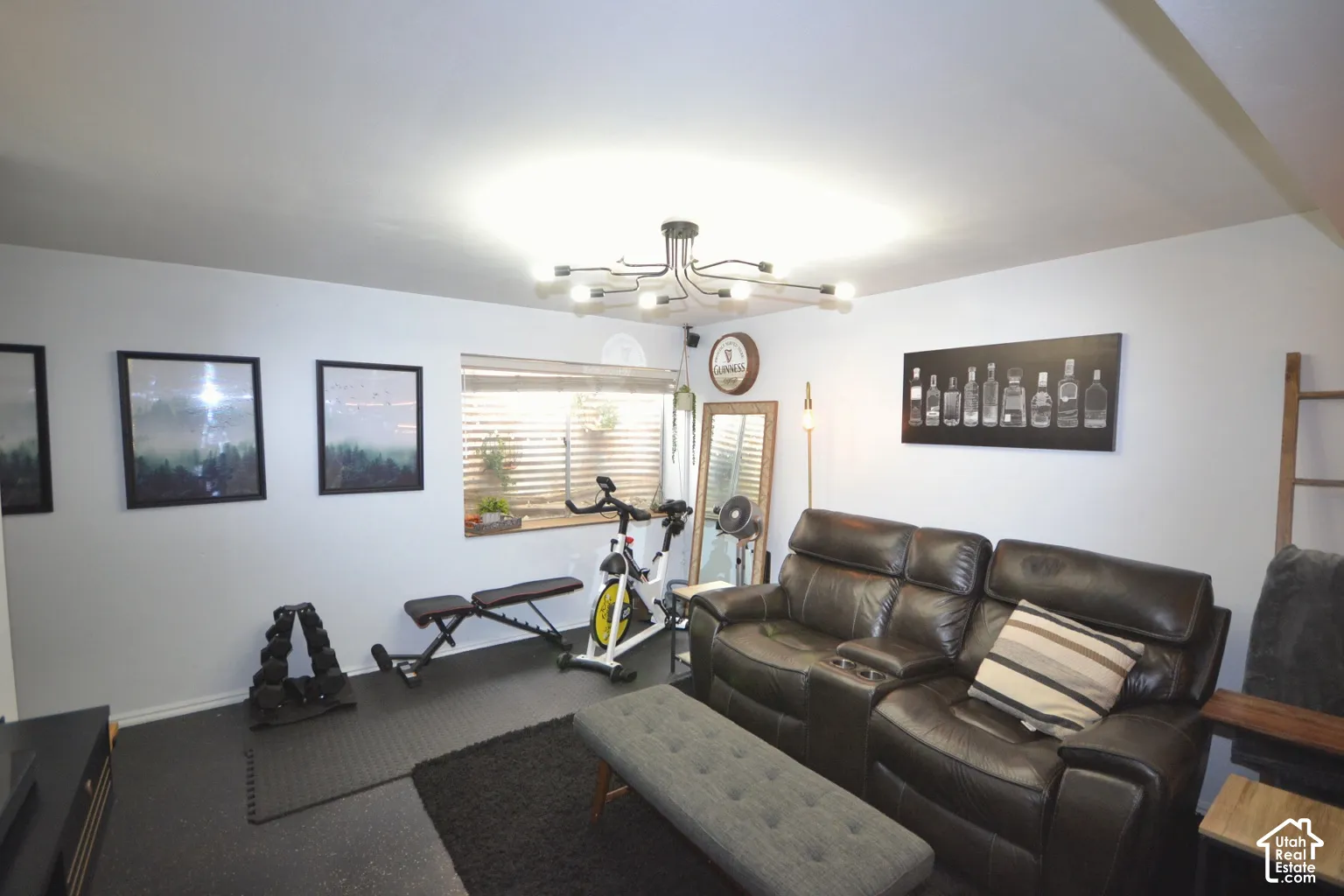 Recessed lighting, window with blinds, modern ceiling fixture, black rubber flooring, and white painted walls