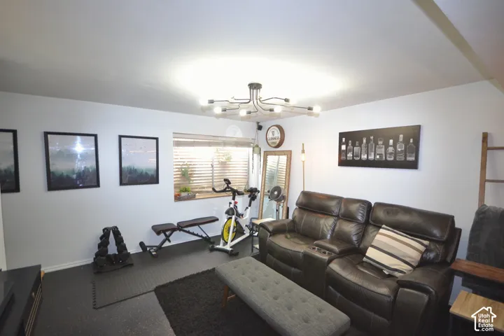 Recessed lighting, window with blinds, modern ceiling fixture, black rubber flooring, and white painted walls
