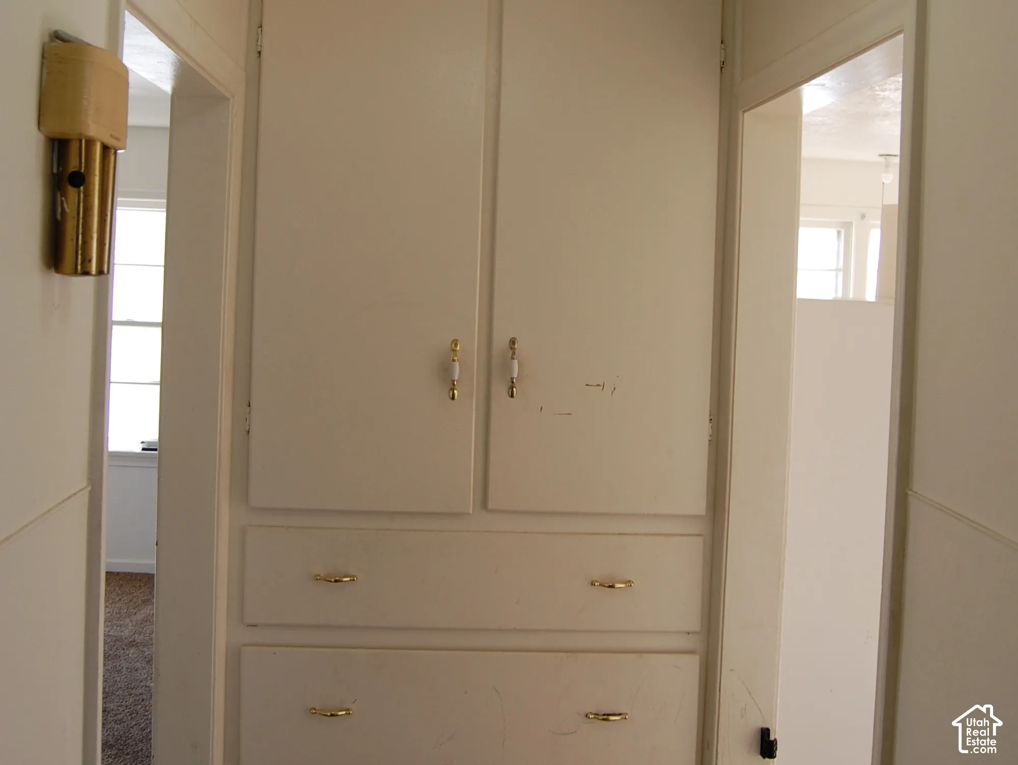 Built-in storage cabinet with multiple drawers and upper cupboards, flush mount ceiling light