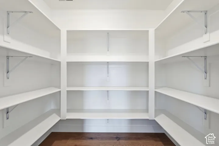 Built-in shelving with white finishes and wood-finish flooring