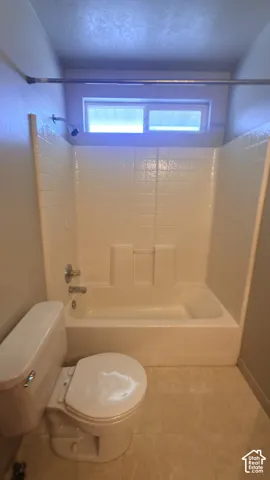 Bathtub and shower combination with a small transom window