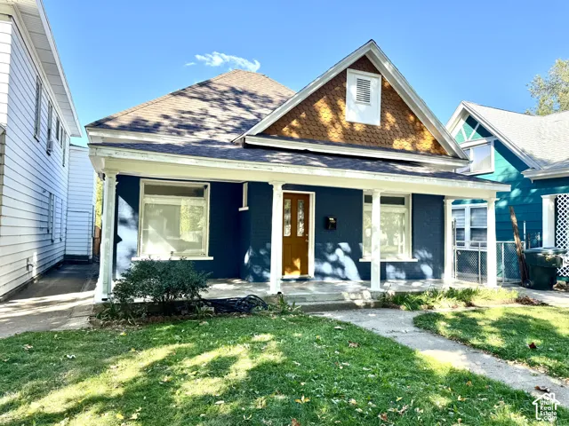 Front exterior with a covered porch featuring white support columns