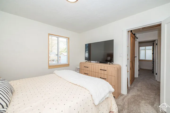 White walls complement wood-finish window trim and a barn door entry