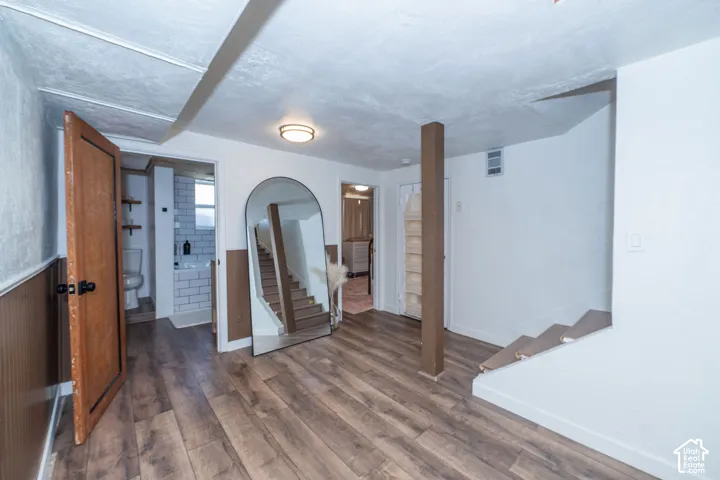 Wood-finish flooring throughout, with wainscoting detailing