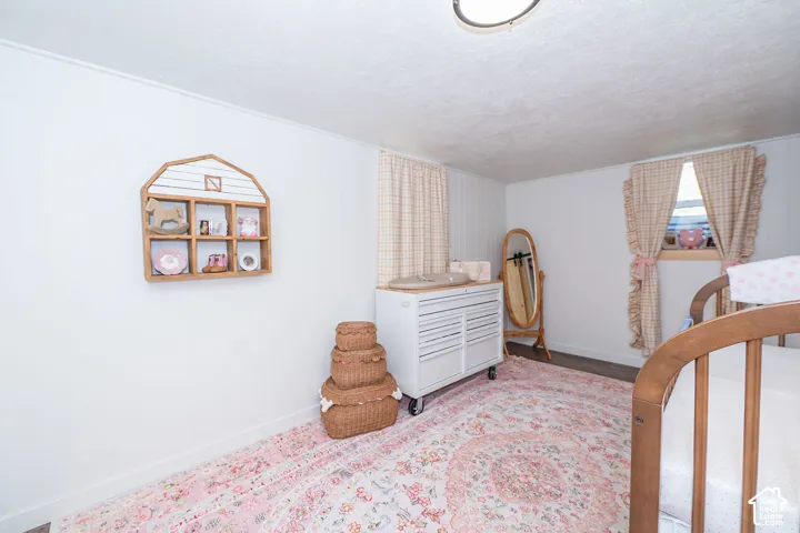 Wood-finish flooring with white wall paneling