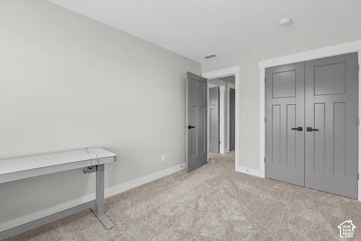 Neutral-toned carpet flooring and light wall finishes