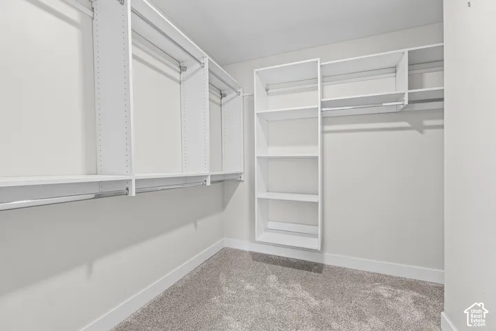 Built-in closet organization system with multiple shelving units and chrome hanging rods