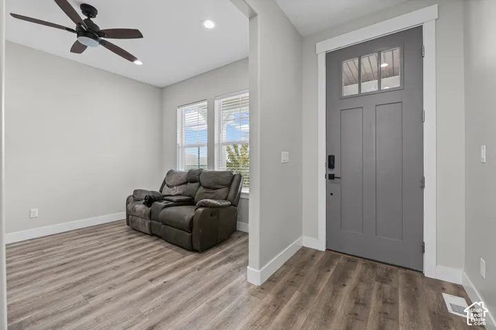 Wood-finish flooring, recessed lighting, and a ceiling fan