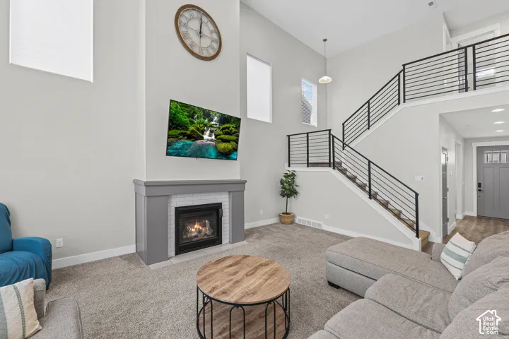Vaulted ceiling with an integrated fireplace and white tile surround