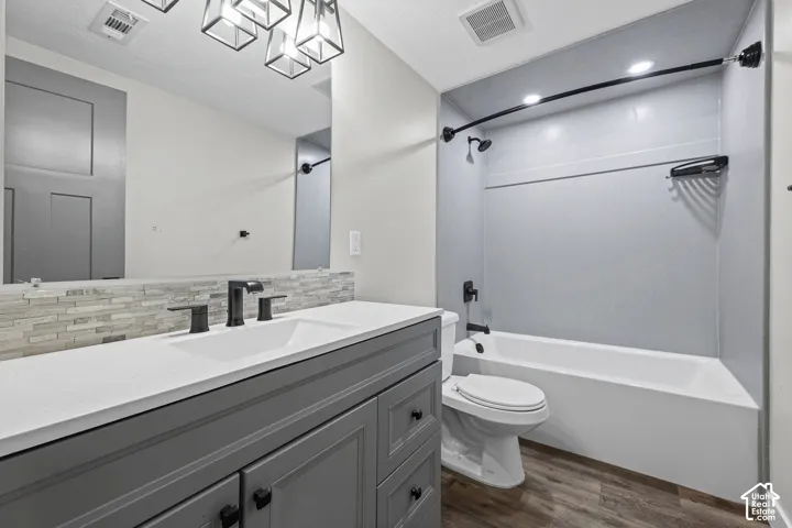 Gray vanity with a white countertop, undermount sink, and matte black fixtures
