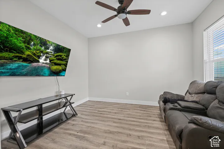 Recessed lighting, ceiling fan, wood-finish flooring, and window with blinds