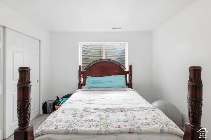 Carpeted flooring with white painted walls and a single window