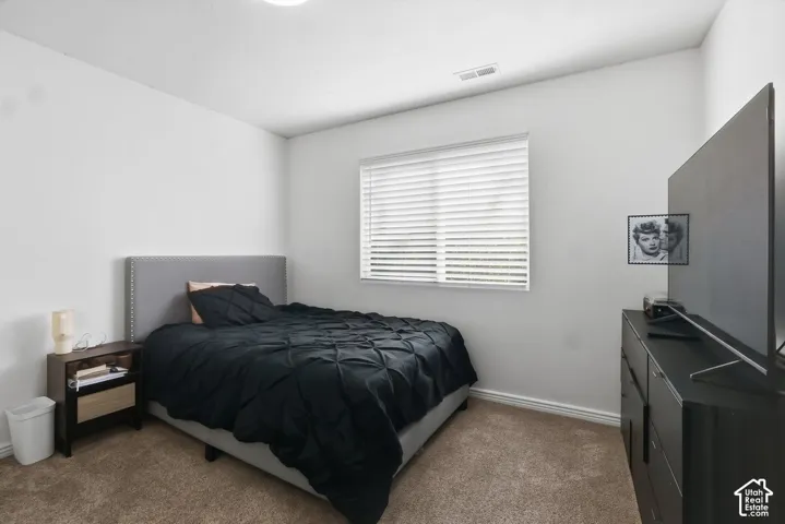 Recessed ceiling light, wall-to-wall carpeting, and a window with blinds