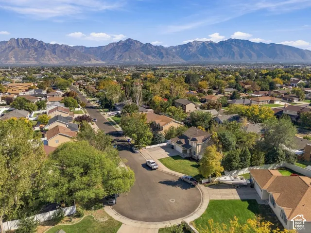 Residential neighborhood with mature trees and mountain scenery