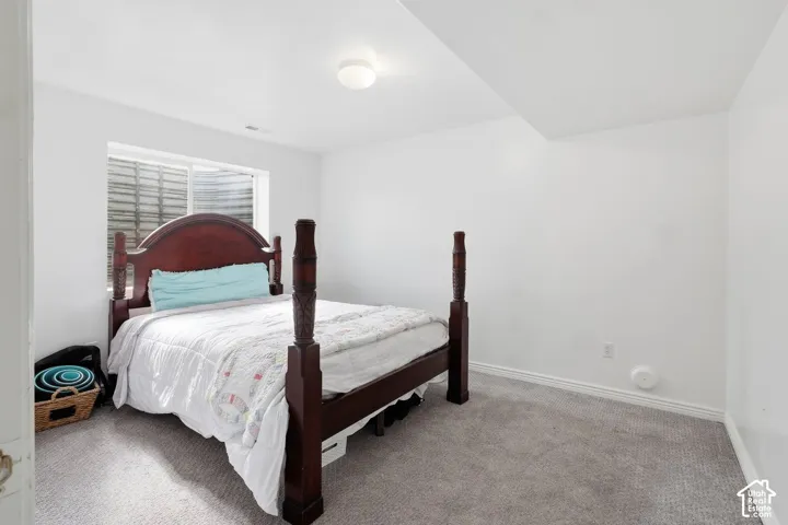 White painted walls with a single window and recessed lighting