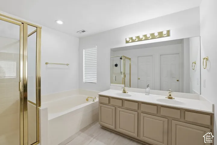 Dual vanity with a white countertop and gold-toned faucets