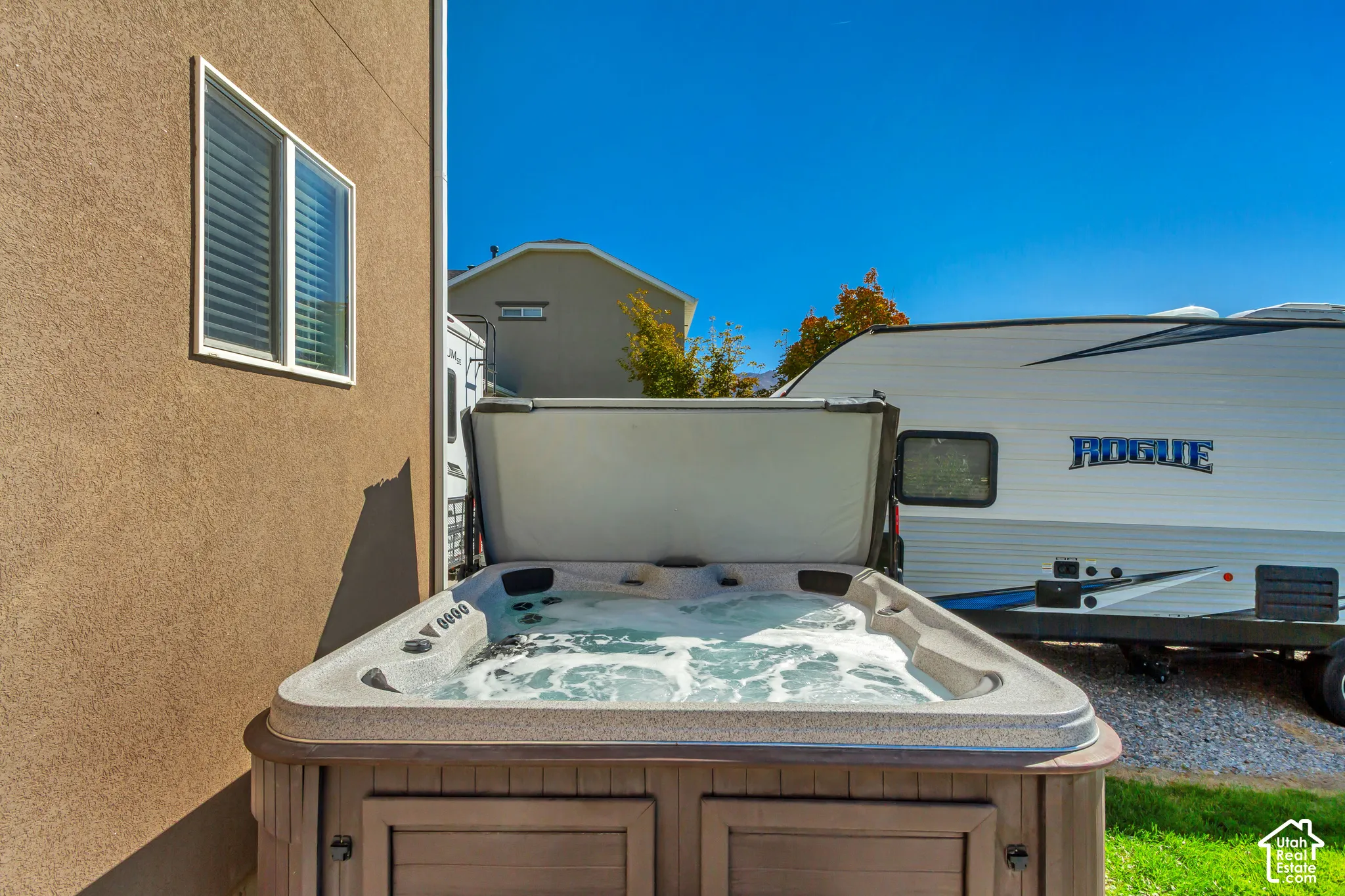 Outdoor spa featuring a protective cover