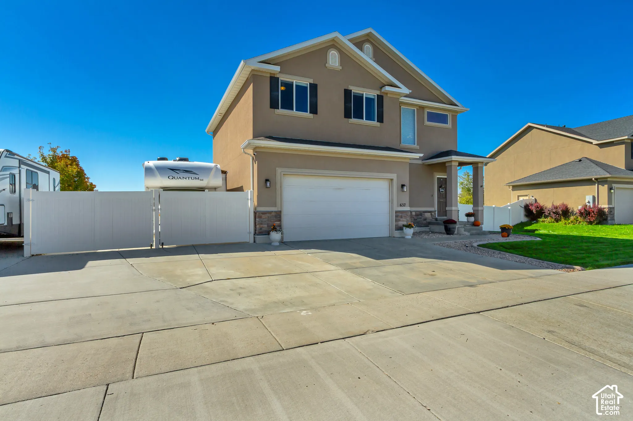 Stucco exterior with stone accents and a covered entry