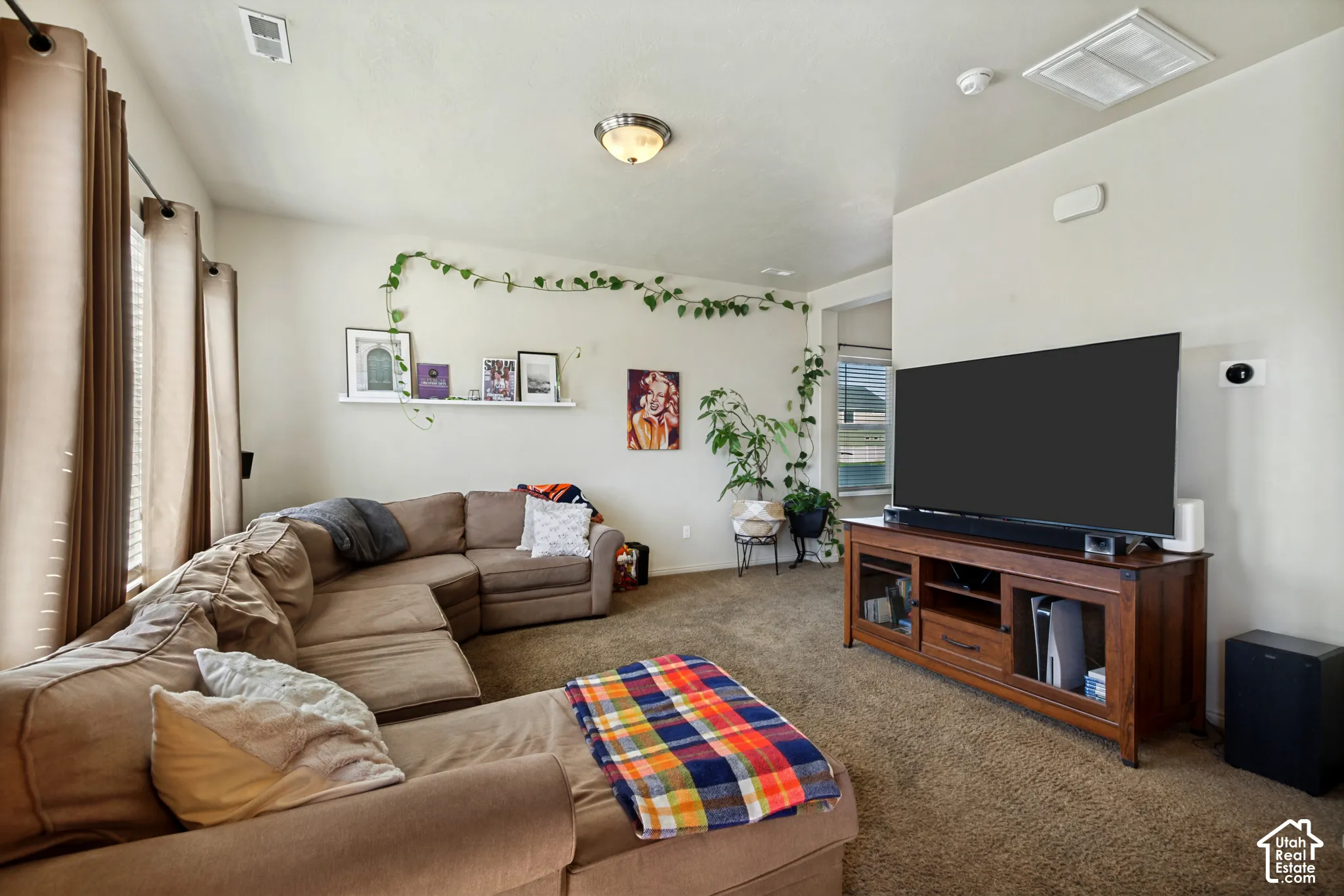 Neutral wall tones, recessed lighting, and a window with blinds