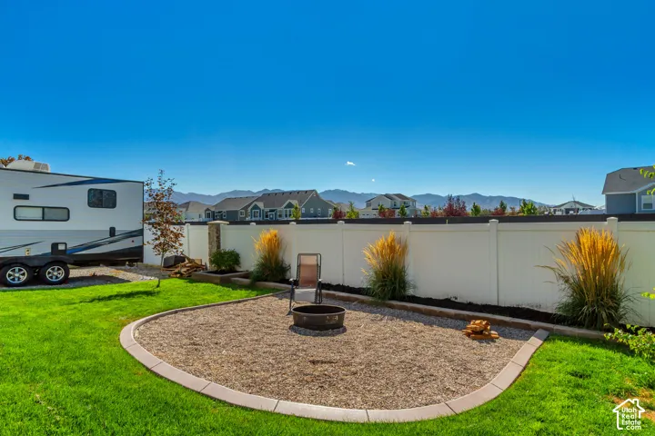 Expansive green lawn with a dedicated fire pit area