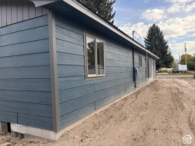 Blue horizontal siding with a concrete foundation