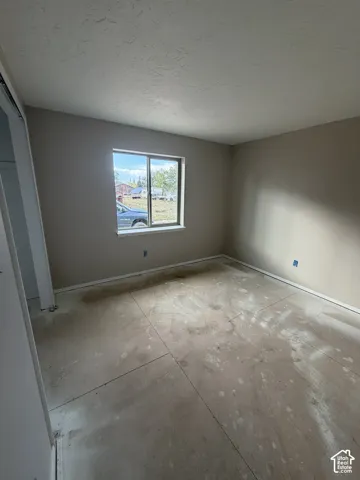 Neutral-toned walls with a window, smooth ceiling finish