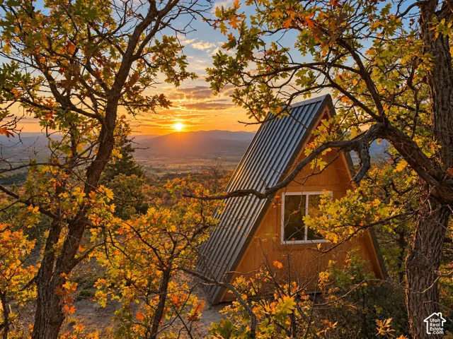 A-frame structure with wood siding, horizontal window, and metal roof