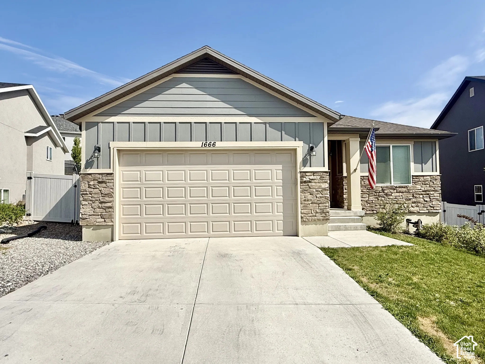 Stone veneer accents, horizontal siding, board and batten siding, attached garage, concrete driveway
