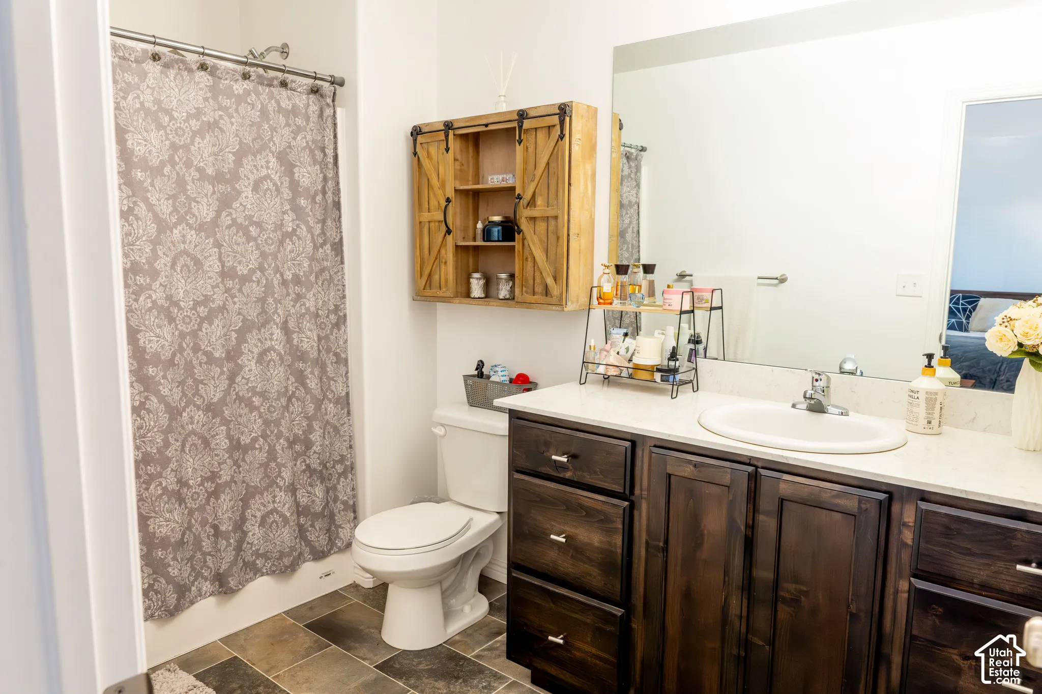 Wood-finish vanity with white countertop and integrated sink