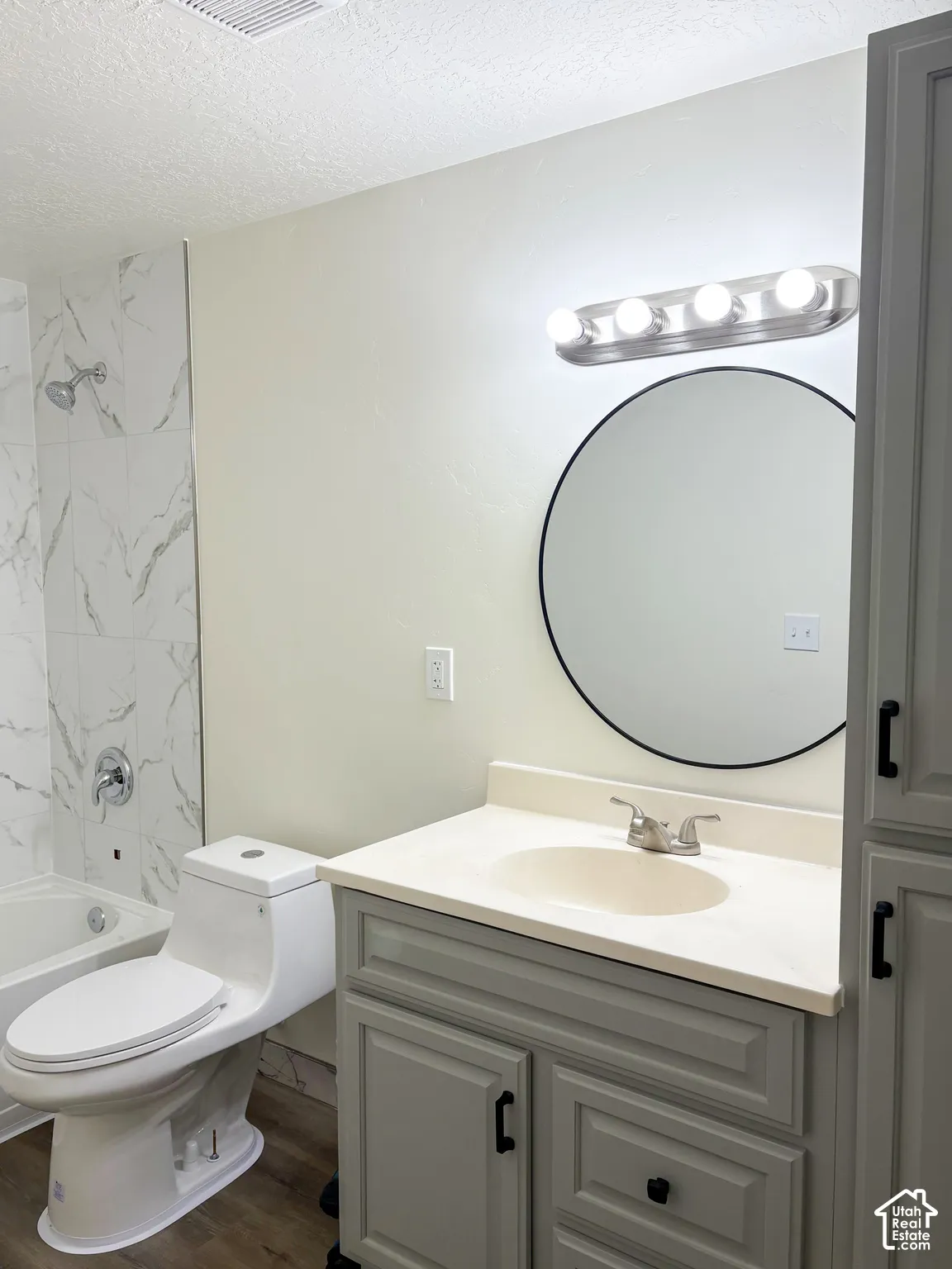 White subway tile shower surround with a chrome shower head and faucet