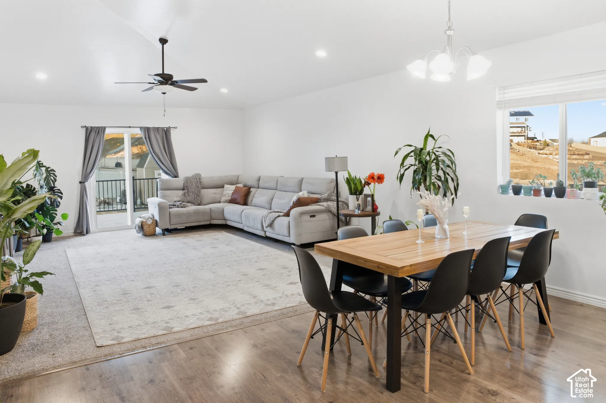 Open-concept living space with vaulted ceilings, recessed lighting, and wood-finish flooring