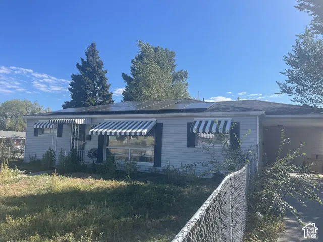 Solar panel array, striped awnings, and a carport