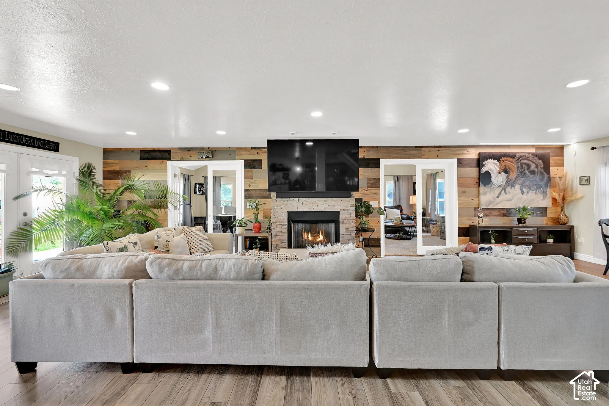 Living space featuring wood-finish flooring and recessed lighting