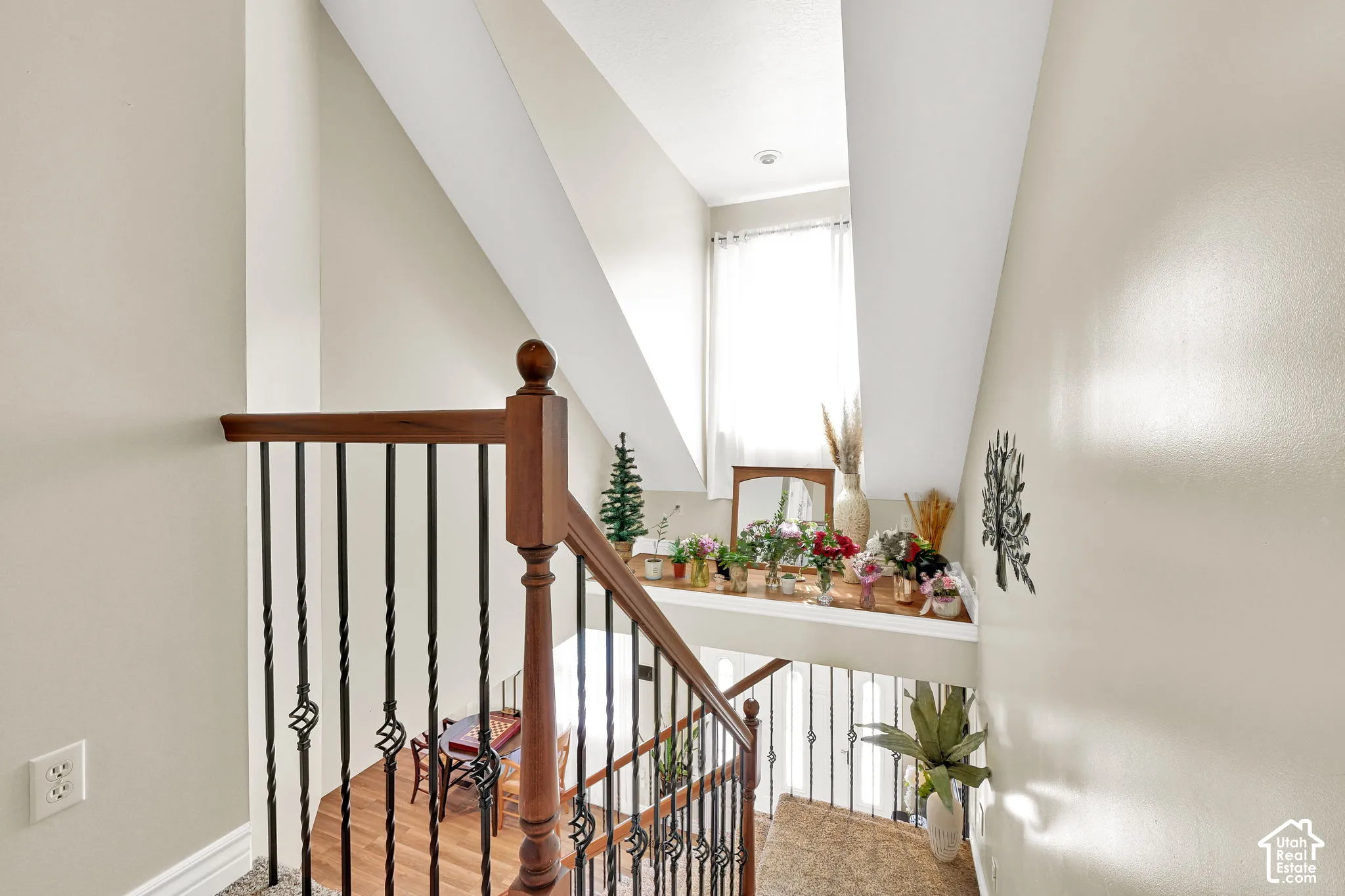 Hardwood staircase with wrought iron balusters and a wood handrail