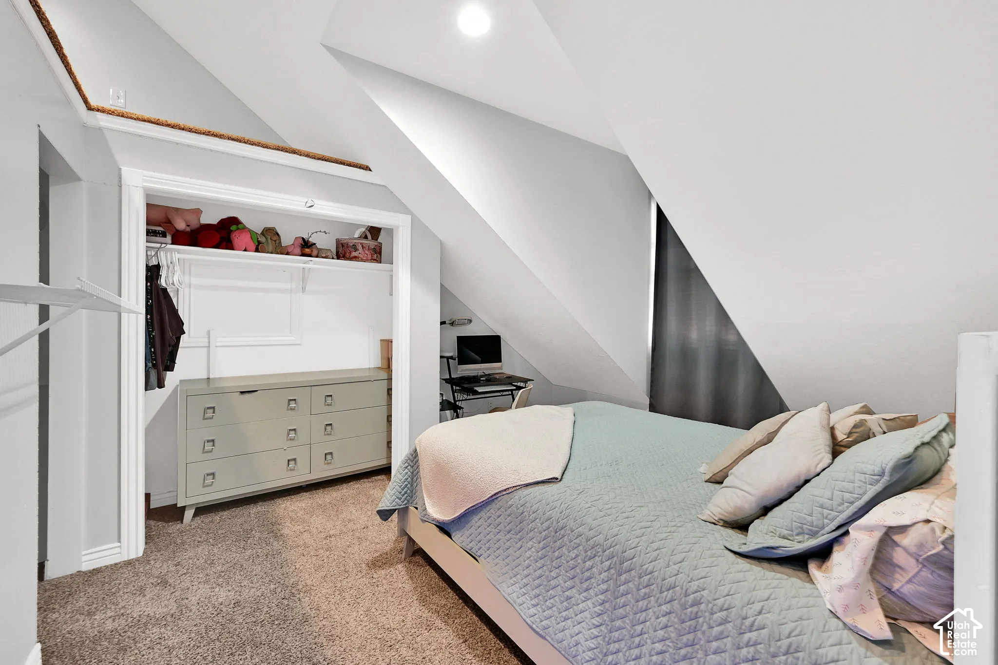 Carpeted flooring with sloped ceilings, recessed lighting, and a built-in closet with shelving