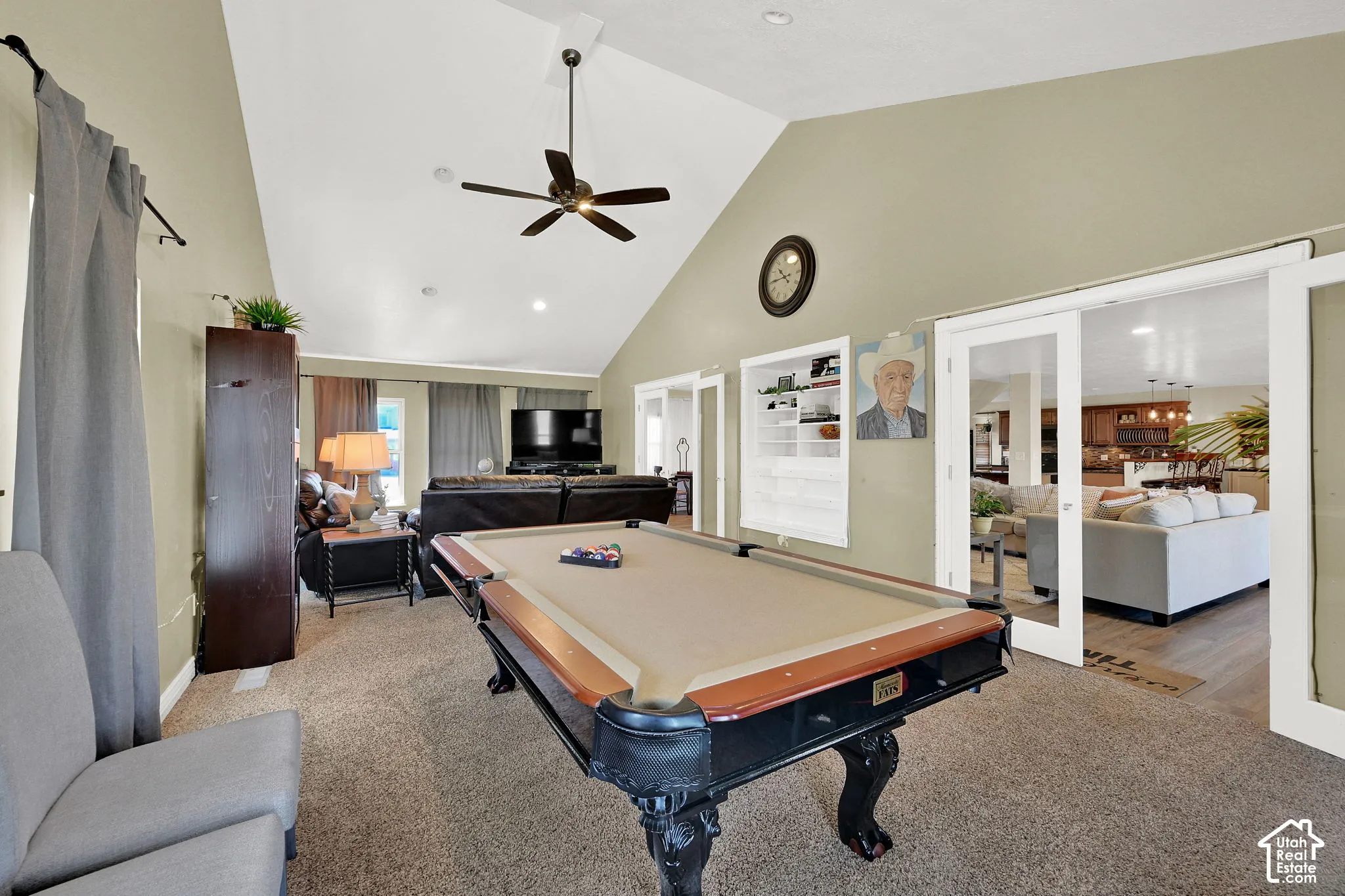 Vaulted ceiling with ceiling fan, recessed lighting, built-in shelving, and white sliding doors