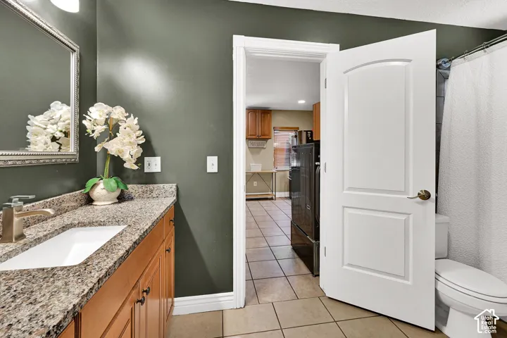 Granite-finish countertop with an undermount sink, brushed nickel faucet, and wood-finish vanity cabinetry